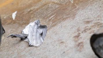 Recochet from a bullet or shell fragment on military armored vehicles. Texture of camouflage armored metal with damage close-up. Armor metal background. Armor deformation from a shell close-up. photo