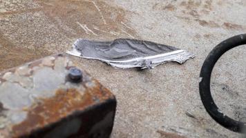 Texture of camouflage armored metal with damage close-up. Armor deformation from a shell close-up. Damaged armor of a Russian armored personnel carrier by shell fragments. War in Ukraine. photo