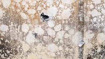 Hole or hole, armor deformation from a projectile close-up. Damaged armor of a Russian armored personnel carrier by shell fragments. War in Ukraine. Russian combat vehicle with holes in the armor. photo