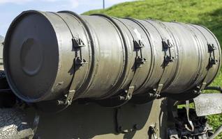 Thermal smoke equipment for placing smoke screens on tanks, combat vehicles and armored personnel carriers. Large cylindrical tanks at the stern of the tank. Barrels are used as tanks for fuel or oil. photo
