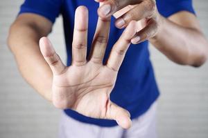 man suffering pain in hand close up photo