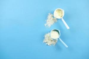 top view of baby milk powder and spoon on tile background. photo