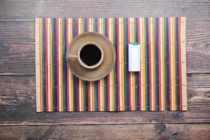 artificial sweetener container and tea cup on table photo