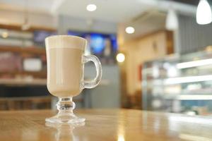 a cup of late coffee with blur cafe background photo