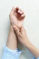 Young women hands suffering wrist pain, photo