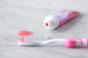 pink color child tooth brush with paste photo