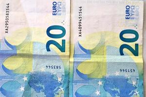 Close up of numerous euro banknotes lying on top of each other. photo