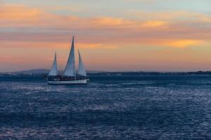 Luxury saiboat on Tagus river at sunset in Lisbon, Portugal photo