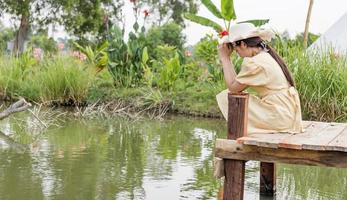side view of the girl alone on the bridge The child is unhappy, feels pressured, thinks about the child's problems. The concept of depression in adolescence. photo
