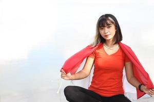 beautiful young asian woman carrying the indonesian flag with a cheerful face photo