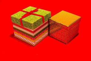 Two Decorative Christmas Gift Boxes On  Red Background photo