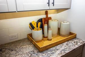 Kitchen Counter With Basket Of Containers And Utensils photo