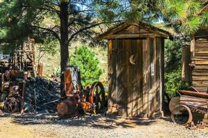 Old Wooden Outhouse In Junkyard photo