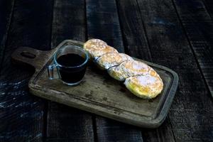 Coffee and donut on wood table photo