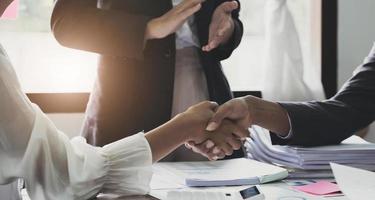 Close up of Business people shaking hands, finishing up meeting, business etiquette, congratulation, merger and acquisition concept photo