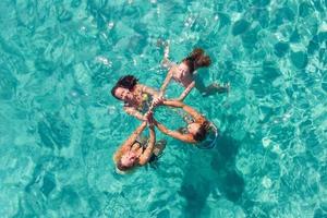 Four Woman Friends Having Fun On The Beach photo