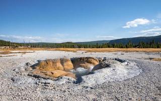 View of Shell spring in Biscuit basin with sky in background at Yellowstone park photo