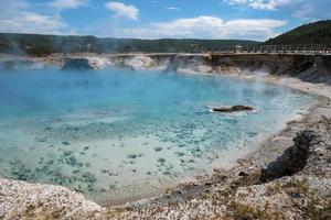 Scenic view of Excelsior geyser and mountain with cloudy sky in background photo