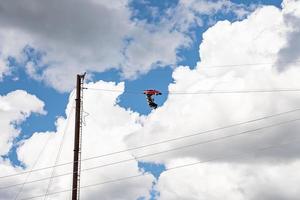 Tourists enjoying unique ride high up with cloudy sky in background photo