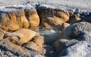 Close-up of boiling water in Shell spring at Yellowstone park during sunny day photo