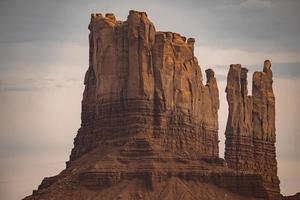 Beautiful rock formations at famous Monument Valley with sky in background photo