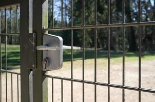 Closed gate, made of steel grating with push handle and mortise lock. No passage. Private territory. photo