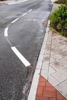 Signs on an asphalt road allowing cycling. Bike lane with symbols and dotted line. Concept of safe movement. photo