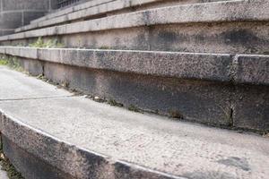 Sturdy concrete steps overgrown with grass outdoors. photo