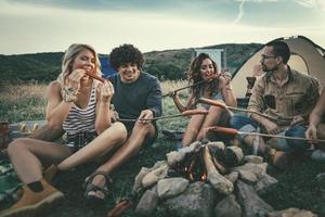 Grilling Sausages Over A Campfire photo