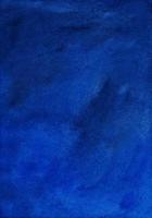 Watercolor old dark azure blue background painting texture. Vintage indigo blue color. Stains on paper. photo