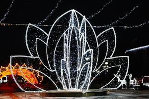 Street Christmas decor. Beautiful luminous flower of lights. photo