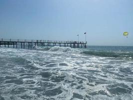 Wooden pier on the beach and the sea in a warm tropical eastern country southern resort photo