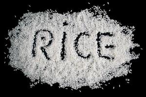 Pile of uncooked white rice on black background. photo