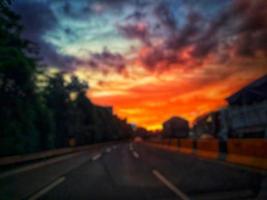 Defocused blurred abstract background of traffic jam at night in east Jakarta. The rear view, the red and yellow lights or the brake lights of the cars are on. photo