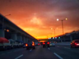 Defocused blurred abstract background of traffic jam at night in east Jakarta. The rear view, the red and yellow lights or the brake lights of the cars are on. photo