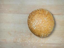 Bun with sesame seeds. Bakery products. Table in the bakery.  Products made from wheat flour of the highest grade. photo