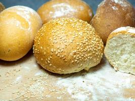 Bakery products.  Buns on a cutting board. Rye and wheat buns. Products from premium wheat flour and rye flour. photo