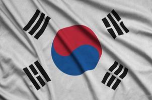 South Korea flag is depicted on a sports cloth fabric with many folds. Sport team banner photo