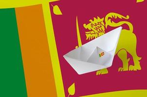 Sri Lanka flag depicted on paper origami ship closeup. Handmade arts concept photo