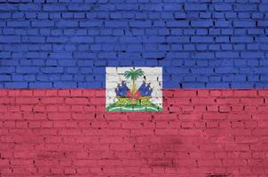 Haiti flag is painted onto an old brick wall photo