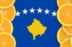 Kosovo flag in citrus fruit slices vertical frame photo