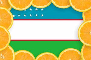 Uzbekistan flag in fresh citrus fruit slices frame photo