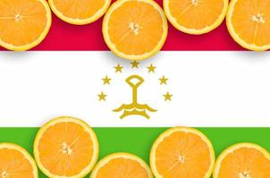 Tajikistan flag in citrus fruit slices horizontal frame photo