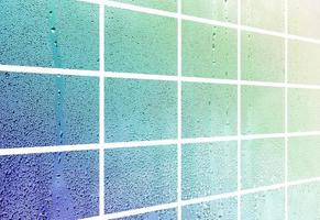 A collage of many different fragments of glass, decorated with rain drops from the condensate. Spring tones with green and blue colors photo