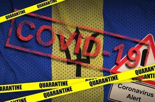 Barbados flag and Covid-19 quarantine yellow tape with red stamp. Coronavirus or 2019-nCov virus photo