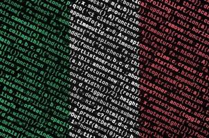 Italy flag is depicted on the screen with the program code. The concept of modern technology and site development photo