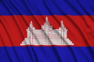 Cambodia flag is depicted on a sports cloth fabric with many folds. Sport team banner photo