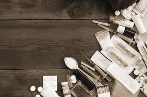 A lot of narcotic substances and devices for the preparation of drugs lie on an old wooden table photo