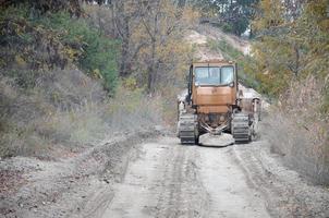 Quarry aggregate with heavy duty machinery. Caterpillar loader Excavator with backhoe driving to construction site quarry photo