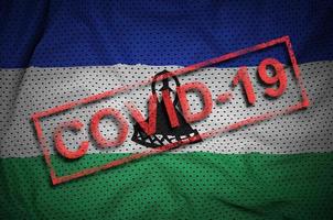 Lesotho flag and red Covid-19 stamp. Coronavirus 2019-nCov outbreak photo